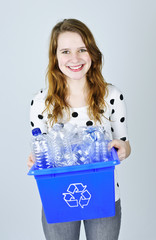 Young woman with recycling box