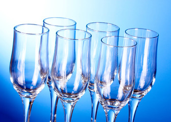 Few empty wine glasses on blue background
