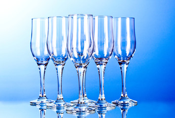 Few empty wine glasses on blue background