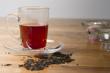 cup of black tea on wooden table