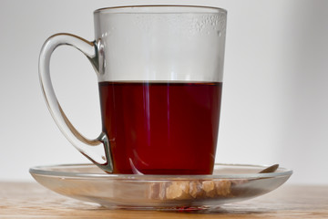 cup of black tea on wooden table