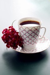 black hot coffee and red flower