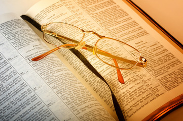 open bible with glasses
