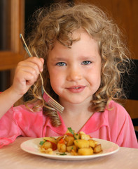 Girl eating potatoes