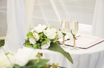 Wineglass,flowers and register book on the table