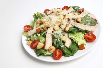 Chicken Cesar salad on white background