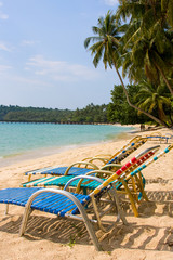 Obraz na płótnie Canvas Chair under palm tree on tropical beach