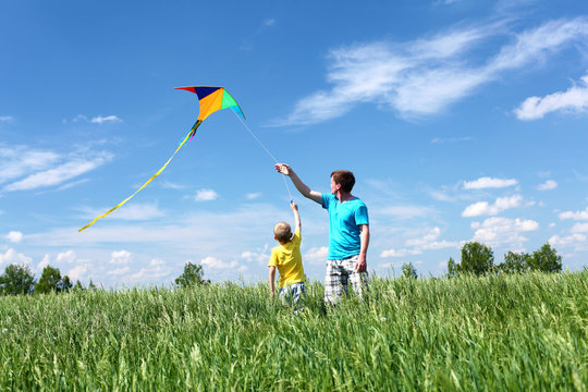 father with son in summer with kite