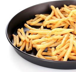 French fries in the pan isolated on white