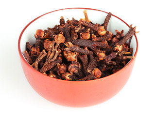 spice cloves in a bowl isolated on white