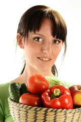 Young woman holding dish with vegetables on white background