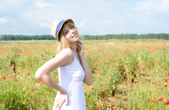 Smiling girl in hat with poppies