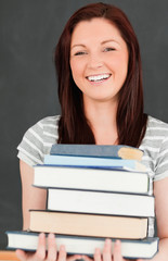 Laughing young woman bringing books