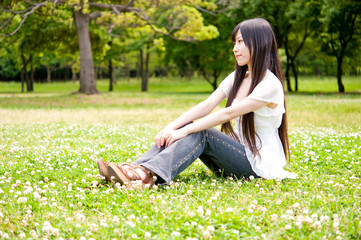 Naklejka na ściany i meble beautiful asian woman relaxing in the park