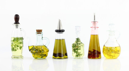 Various bottles of olive oil with herbs inside
