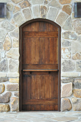 Wooden door on stone wall