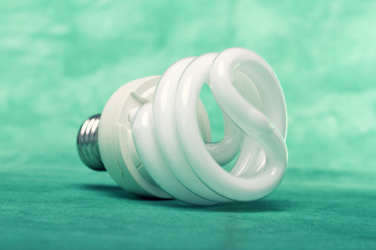 Light bulb on green background