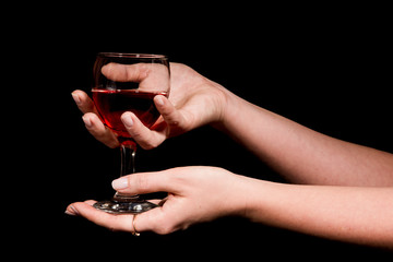 Glass with a red wine in a female hand