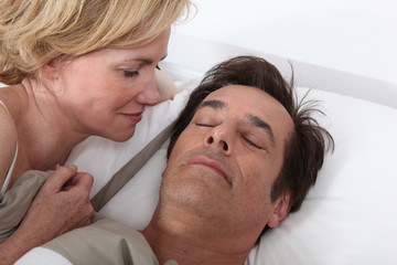 Fototapeta premium Wife watching husband sleeping