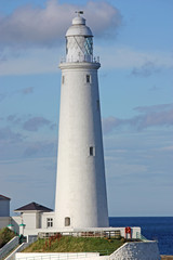 Fototapeta na wymiar A Traditional Tall British Coastal White Lighthouse.