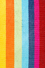 Multicolored striped canvas background, woven texture
