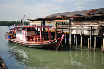 Fototapeta na wymiar wooden house and fishing boat