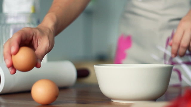 Breaking egg into bowl, slow motion