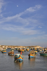 Fototapeta na wymiar boats in harbor and moon