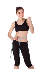 Fitness woman measuring her waist