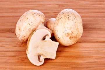 Champignon on wooden background