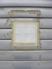 white poster with tape on grunge roller shutter