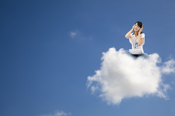 smiling woman listen to music and sitting on the cloud