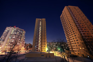 Fototapeta na wymiar Dwelling district with skyscraper in evening in winter