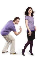 man going to smack with his fingers on back of young wife