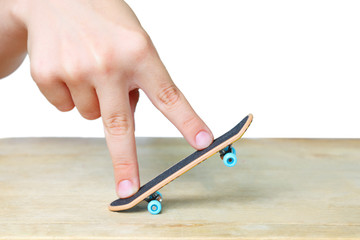 Toy skateboarding concept with miniature children finger board