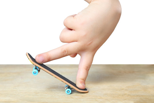 Toy skateboarding concept with miniature children finger board