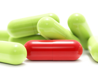 Red and green pills on white background, isolated