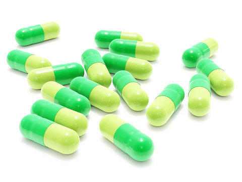 Many green pills on white background, isolated