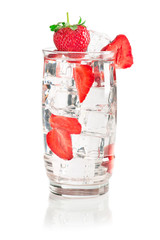 Glass of iced mineral water with ice cubes and strawberry