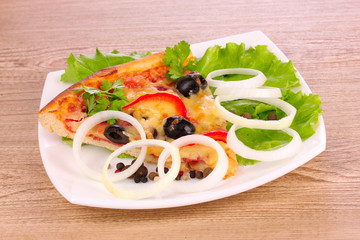 tasty of pizza on a plate on a wooden background