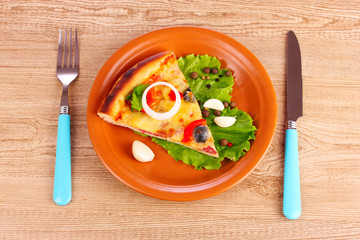 tasty of pizza on a plate on a wooden background