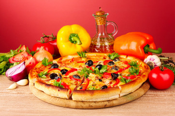 pizza and vegetables on a red background