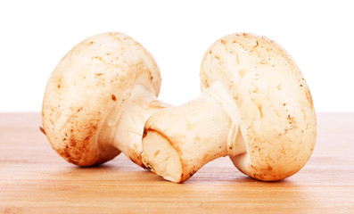 two mushrooms on wooden