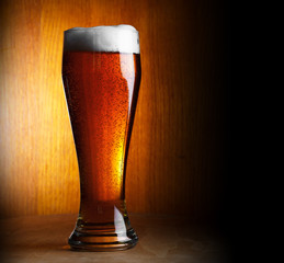 glass of beer on dark background with copy-space