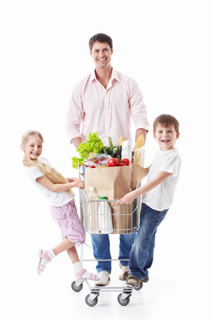A man and two children with a cart with food