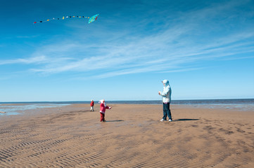 Mother and daughter fly a kite