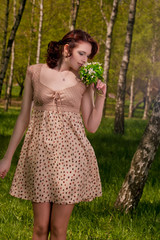 portrait of young cute female with snowdrops