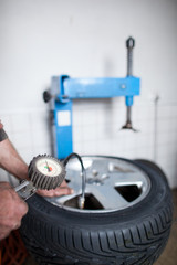 mechanic changing a wheel of a modern car