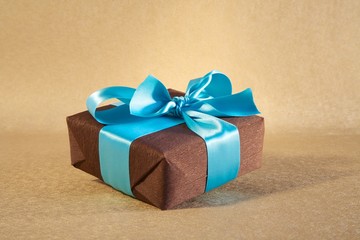 brown gift box with cyan bow