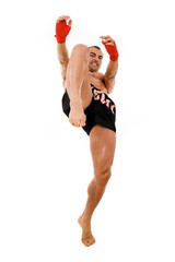 Young Boxer fighter making a kick over white background